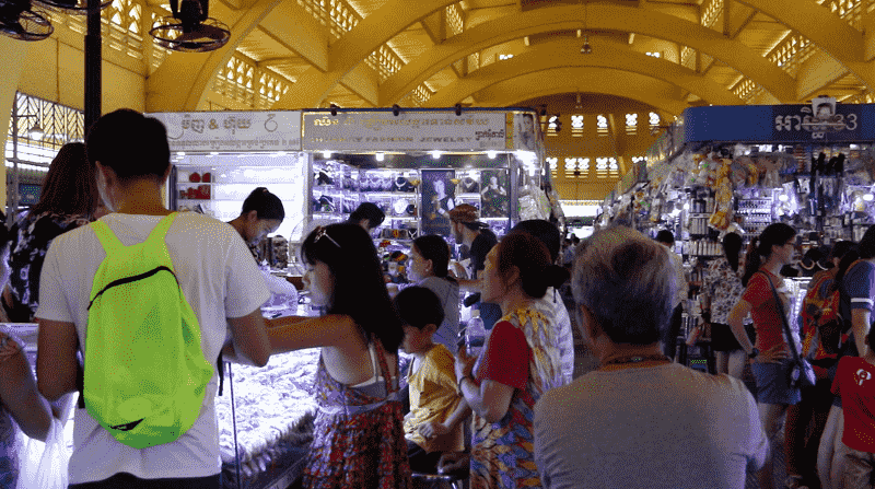 People shop at a market in Phnom Penh
